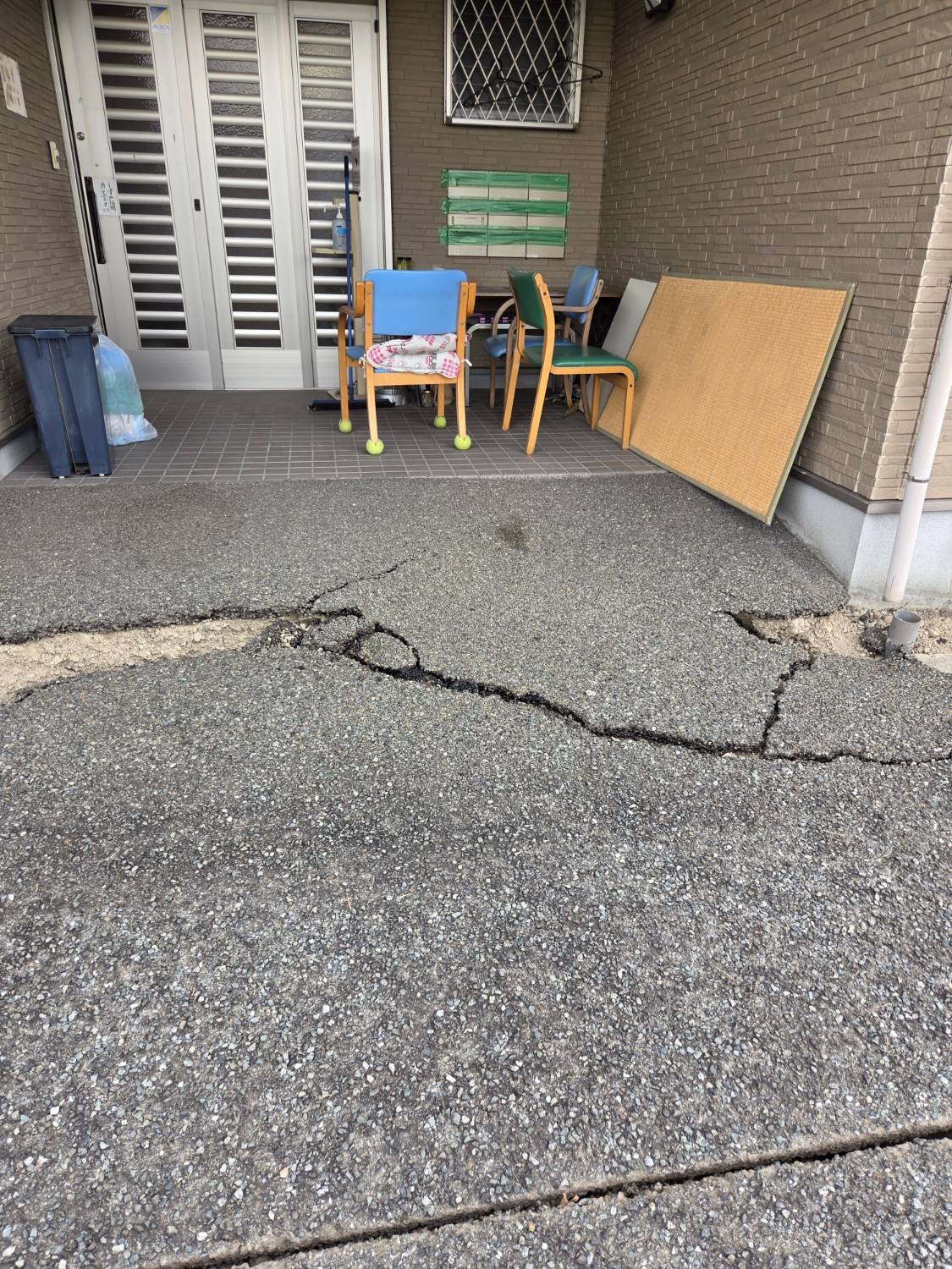 玄関前の地面に亀裂が入っている様子